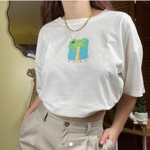 Vintage white tee with palm tree graphic.